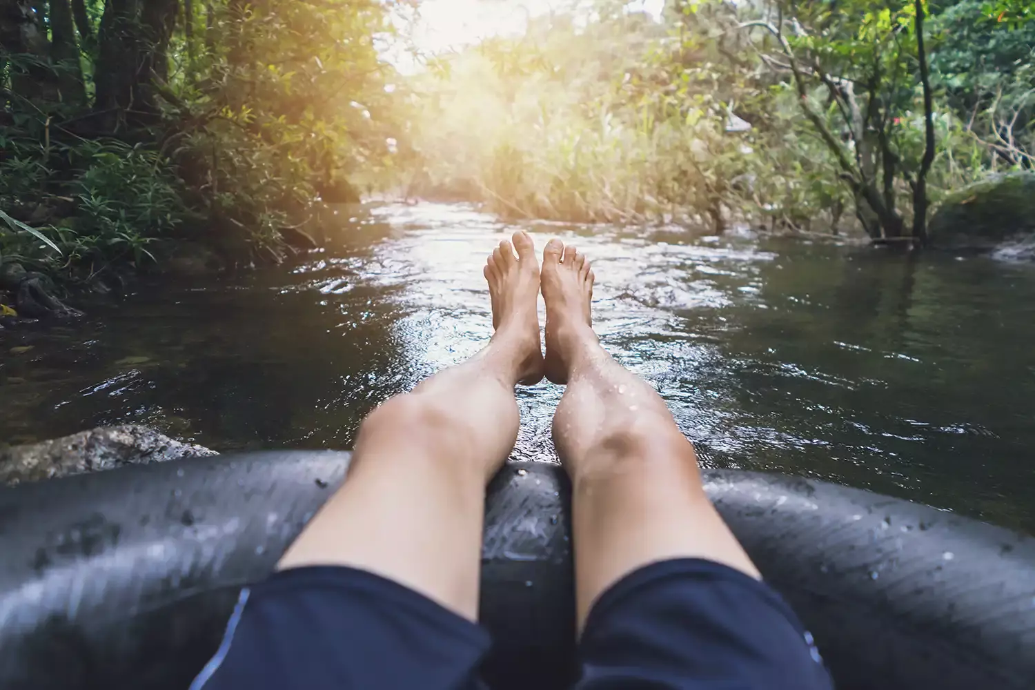 A man tubing down a river in the Smoky Mountains.