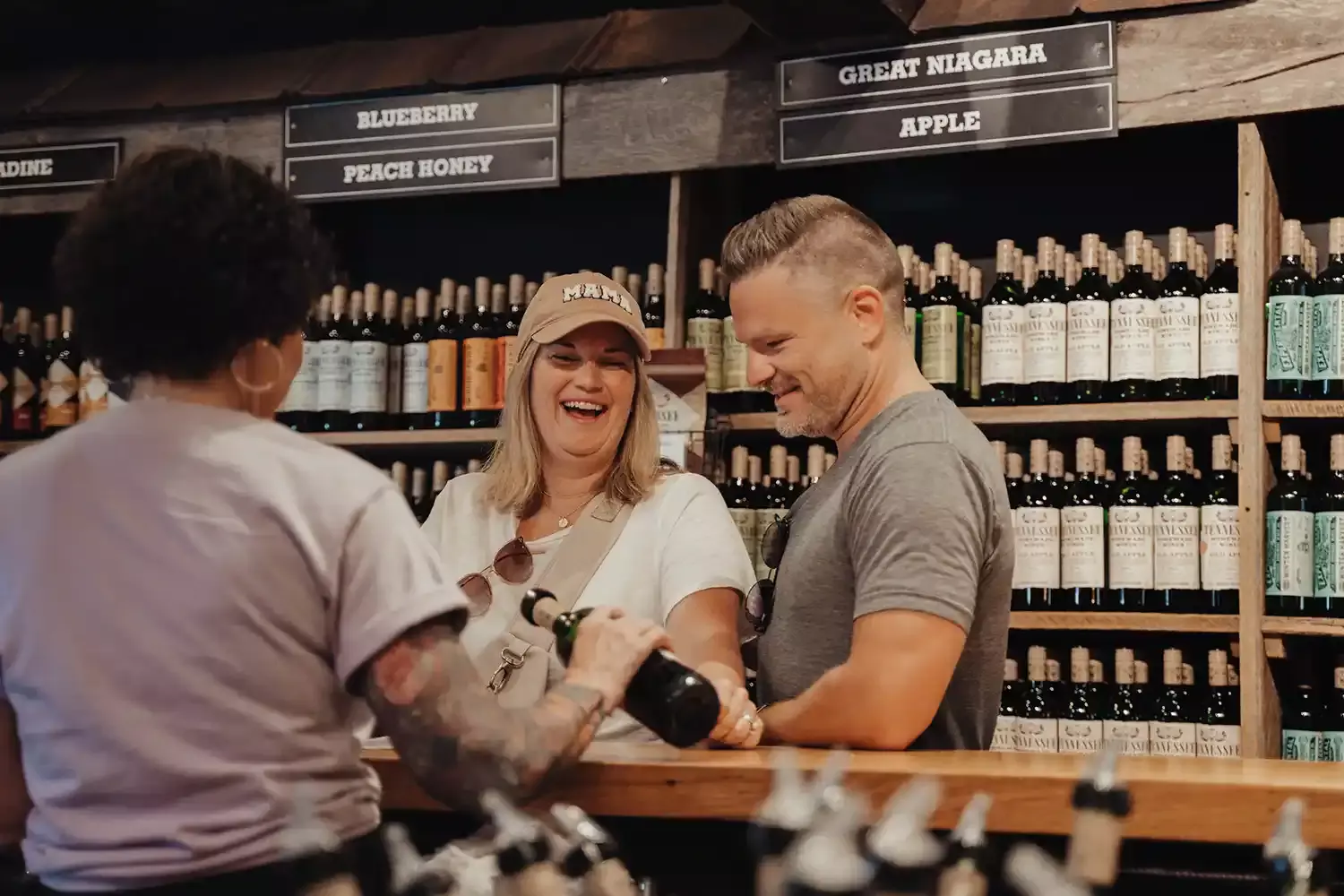 A man and woman enjoying free wine tastings at Tennessee Homemade Wines in Gatlinburg.